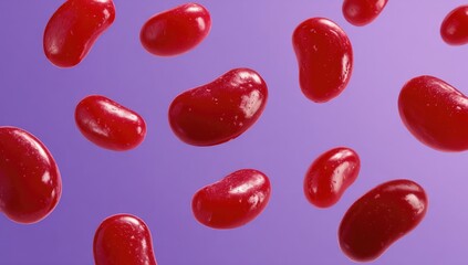 Vibrant red jelly beans in mid-air against a purple background