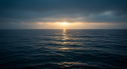 Serene sunset over the sea with golden reflections on the water surface