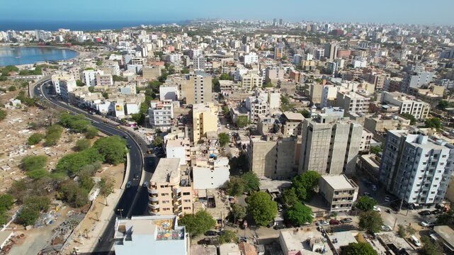 SENEGAL - 7.14.2025 - Beautiful aerial footage panning from city buildings to the water off the coast of Dakar, Senegal.