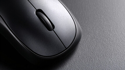 close-up of single modern black wireless computer mouse with smooth curves on light matte backdrop, sharp surface detail, minimalist tech accessory styling with ample negative space