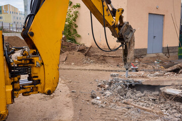 A bustling construction site filled with heavy machinery and ongoing demolition work