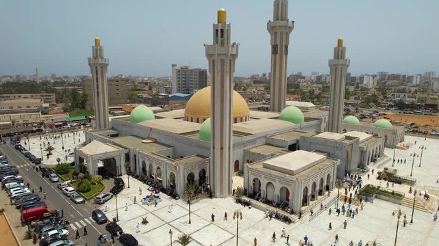 SENEGAL - 7.14.2025 - Wonderful aerial footage of Muslims walking up to the Massalikoul Djinane Mosque in Dakar, Senegal.