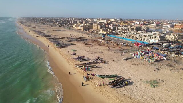 SENEGAL - 7.16.2025 - Very good aerial view of waves lapping the beach of Senegal's Island of Saint-Louis.