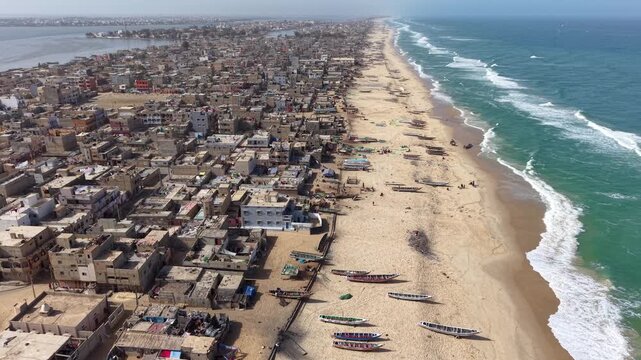 SENEGAL - 7.16.2025 - Gorgeous aerial view of waves lapping the shores of Senegal's Island of Saint-Louis.