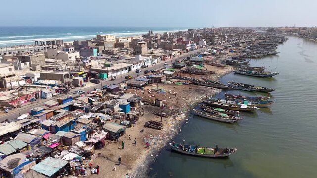 SENEGAL - 7.16.2025 - Great aerial view of a waterfront goat market on a harbor on Senegal's Island of Saint-Louis.