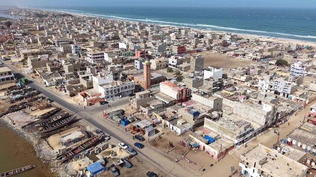 SENEGAL - 7.16.2025 - Great aerial footage moving over Senegal's Island of Saint-Louis, headed towards the beach.