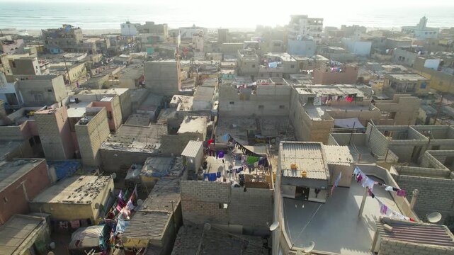 SENEGAL - 7.16.2025 - Great aerial footage circling clockwise around rooftops in a residential area on Senegal's Island of Saint-Louis.