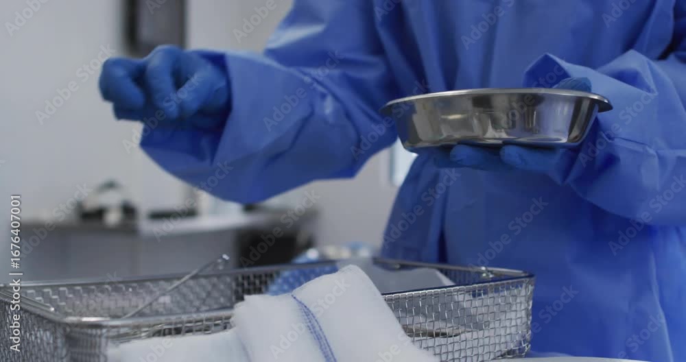 Poster on css code appearing practitioner adjusting kidney-dish grabbing forceps preparing instruments