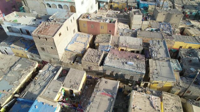 SENEGAL - 7.16.2025 - Strong aerial footage moving over rooftops in a poor neighborhood on Senegal's Island of Saint-Louis.