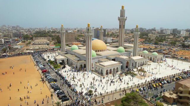 SENEGAL - 7.14.2025 - Terrific aerial footage of Muslims leaving the Massalikoul Djinane Mosque in Dakar, Senegal after prayer.