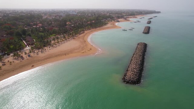 SENEGAL - 7.21.2025 - Wonderful aerial footage moving up the coastline and sandbars of the seaside resort on Saly, Senegal.
