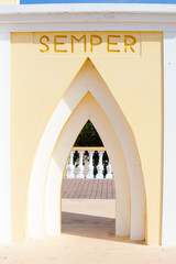 Yellow monument arch with SEMPER inscription