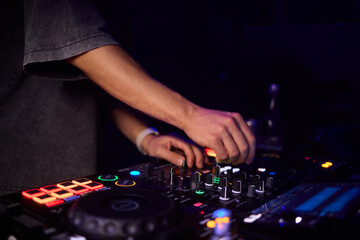 Witness the DJ mixing equipment performing live and in action at a vibrant music event