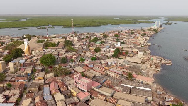 SENEGAL - 7.31.2025 - Good aerial footage panning a mosque on the island of Joal-Fadiouth, Senegal.