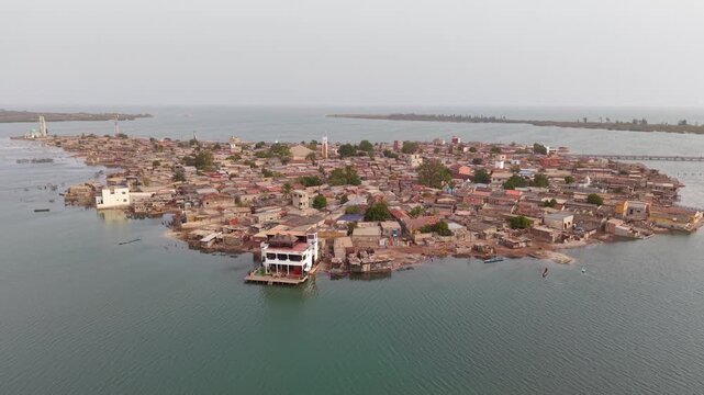 SENEGAL - 7.31.2025 - Excellent aerial footage drawing back from the island of Joal-Fadiouth, Senegal.