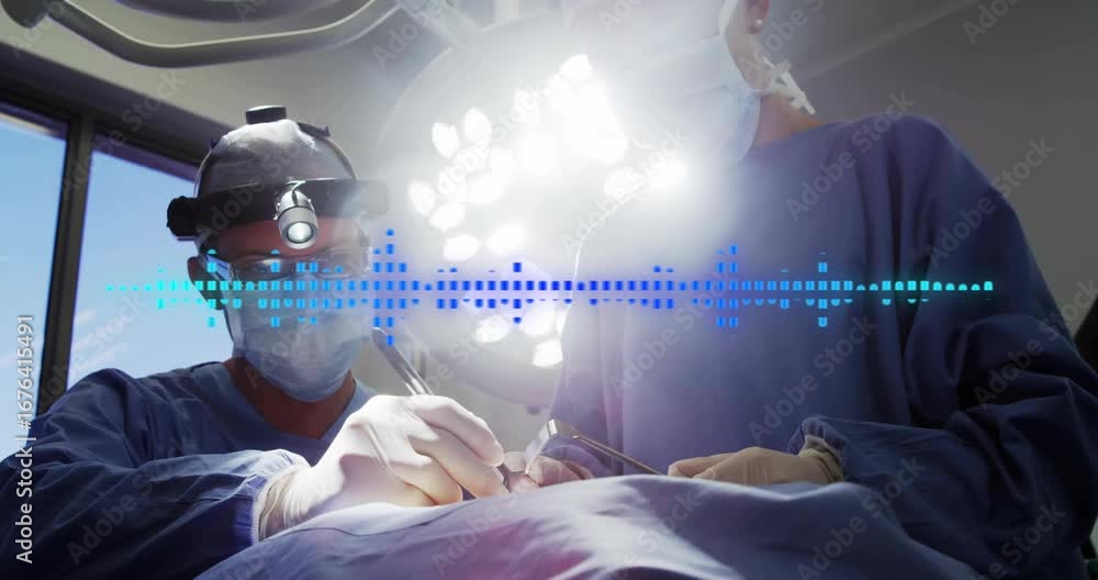Aufkleber headlamp illuminating field surgical team making incision while waveform monitoring dissection