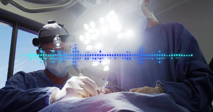 Headlamp illuminating field surgical team making incision while waveform monitoring dissection