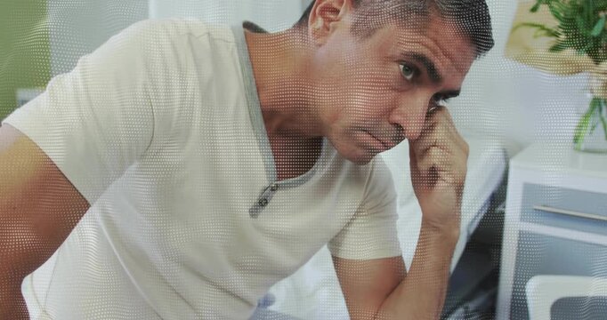 Clinical patient on bed receiving support after news leaning forward pressing forehead pensively