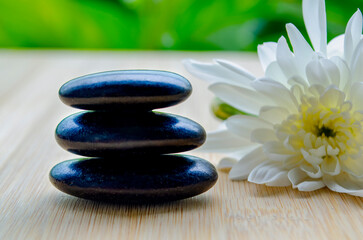 Fototapeta premium Balanced arrangement of zen stones with peaceful setting on wood with customizable space for text