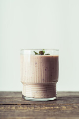 Blueberry and bananas smoothie on the rustic background. Selective focus.