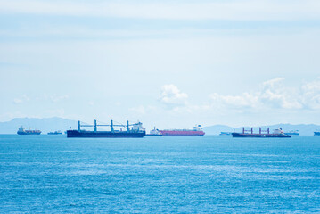 Panoramic view of the sea near the coast of Panama. Several cargo ships, sail across the blue...