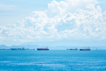 Panoramic view of the sea near the coast of Panama. Several cargo ships, sail across the blue...