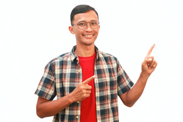 An Asian man points up with a happy expression.