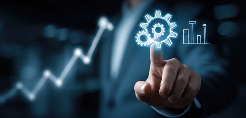 A hand points to glowing gears and graphs, symbolizing business growth and strategy