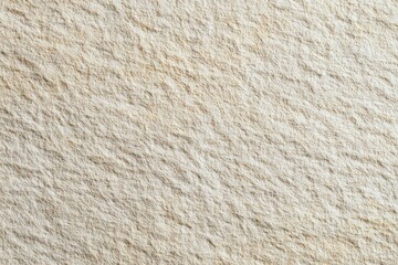 Close-up view of a light beige, textured surface