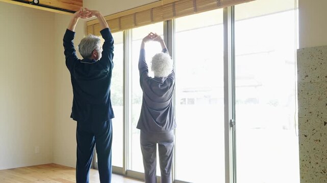Senior couple stretching in pajamas
