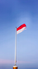 The Indonesian national flag fluttered loudly against the backdrop of a bright blue sky in the morning.
