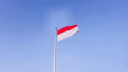 The Indonesian national flag fluttered loudly against the backdrop of a bright blue sky in the morning.