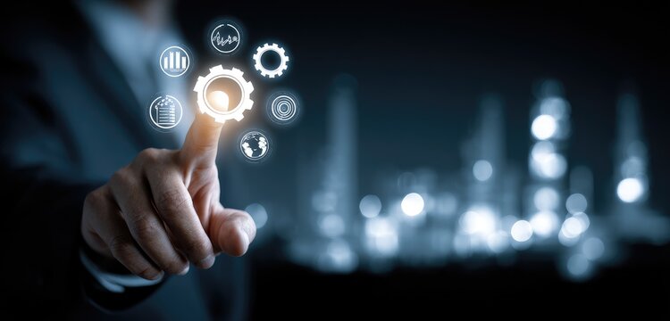 Businessperson's finger points at glowing gear icons over blurred city lights