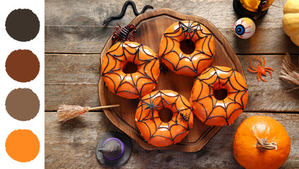Tasty donuts with decorations for Halloween on wooden background