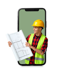 Young male engineer with blueprint on green background