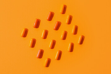 Many pills on orange background