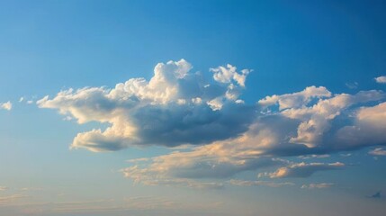 Obraz premium Fresh and Light Summer Vibe: Fluffy White Clouds Over Clear Blue Sky on Sunny Day