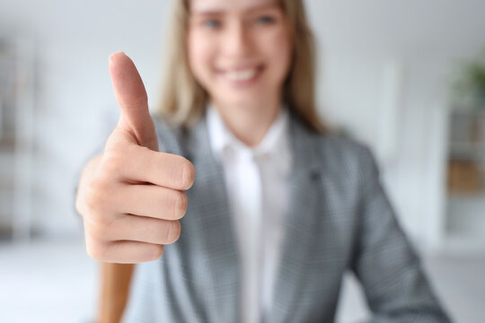 Young businesswoman using virtual screen in office, closeup