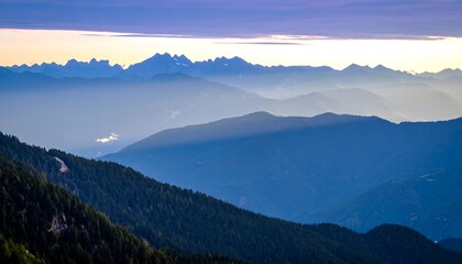 Misty mountain range at sunrise