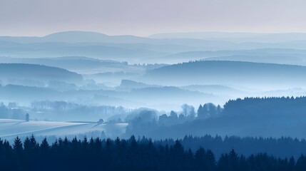 Fototapeta premium A serene landscape view of rolling hills, painted in shades of pale blue, showcasing a tranquil and misty atmosphere.