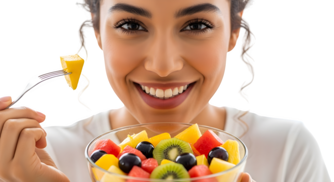 Smiling woman eating a colorful fruit salad with a fork promoting healthy eating