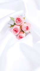 Delicate pink roses on white fabric