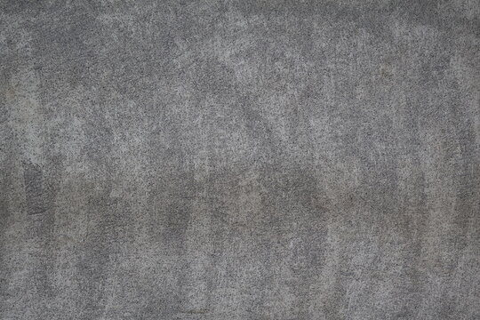 A modern cement wall featuring abstract dotted patterns across its surface, blending raw industrial texture with artistic detail, ideal for contemporary architectural designs and stylish interior