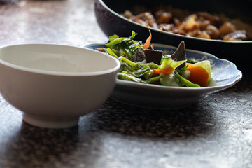 A home-cooked meal in Vietnam with braised pork and stir-fried vegetables