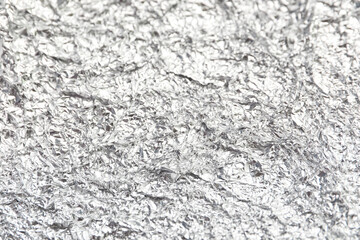 Texture of crumpled aluminium foil as background, closeup