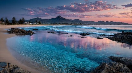 Naklejka premium Peaceful beach view at sunset with orange skies and glassy waves gently lapping the shore 