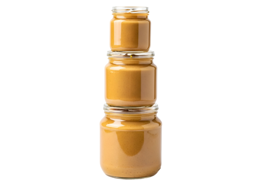 Three glass jars filled with a light brown spread, stacked neatly against a black background.