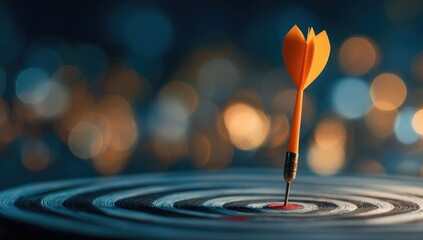 Orange dart in bullseye, success concept