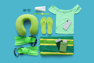 Composition with passports, mobile phone and beach accessories on blue background