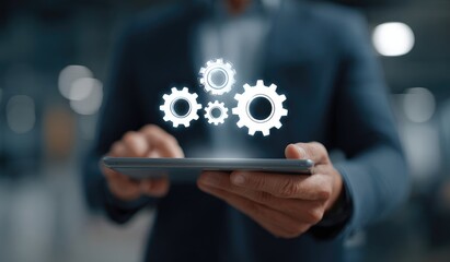 Businessman holds tablet displaying digital gears